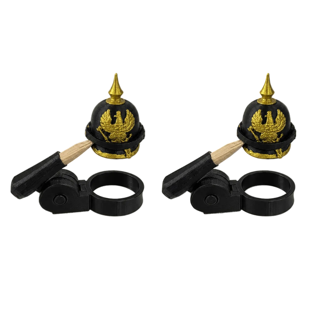 Two black and gold helmet-shaped objects with wooden handles on a white background