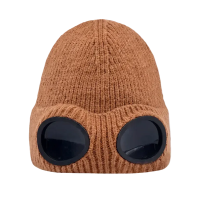 A brown ribbed knit beanie hat with two large black oval visor-like details on the front, shown against a plain white background.